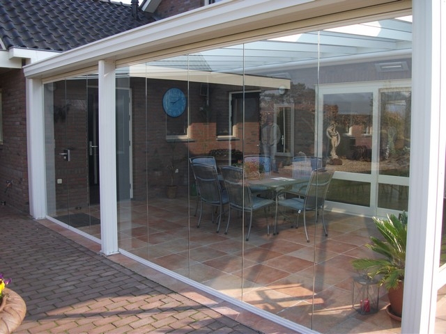 Black aluminum bifold glass doors fully opened connecting indoor living space to outdoor patio area