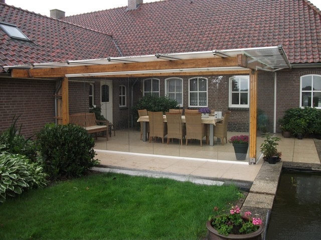 Black aluminum bifold glass doors fully opened connecting indoor living space to outdoor patio area