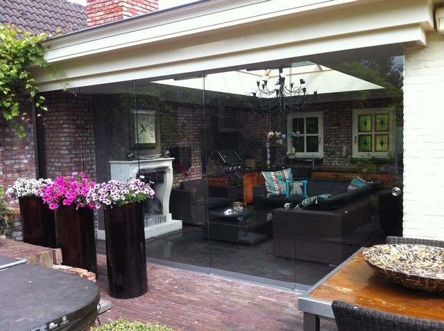 Black aluminum bifold glass doors fully opened connecting indoor living space to outdoor patio area