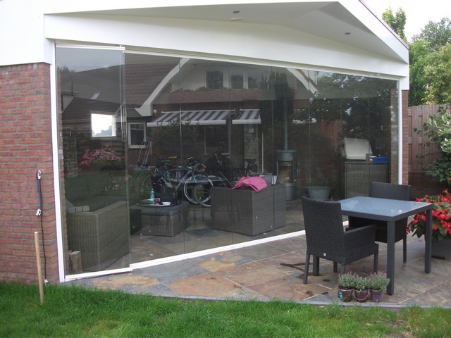 Black aluminum bifold glass doors fully opened connecting indoor living space to outdoor patio area
