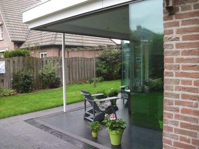 Black aluminum bifold glass doors fully opened connecting indoor living space to outdoor patio area