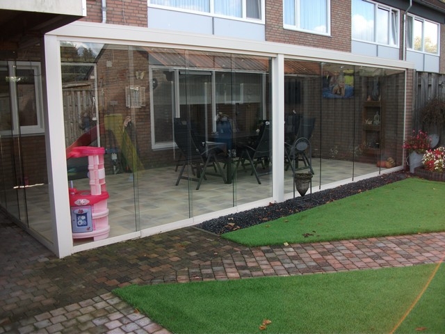 Black aluminum bifold glass doors fully opened connecting indoor living space to outdoor patio area