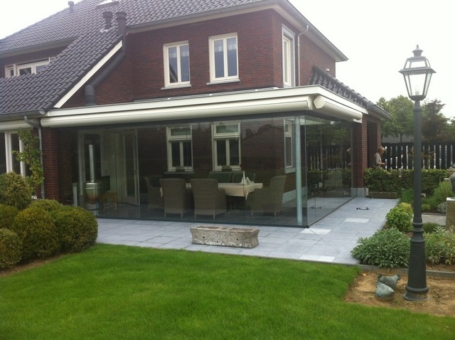 Black aluminum bifold glass doors fully opened connecting indoor living space to outdoor patio area