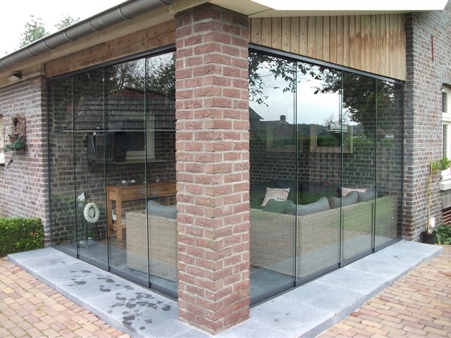 Black aluminum bifold glass doors fully opened connecting indoor living space to outdoor patio area