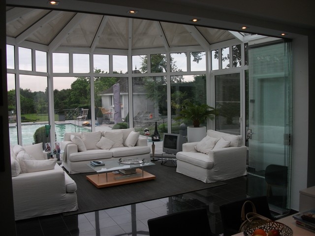 Black aluminum bifold glass doors fully opened connecting indoor living space to outdoor patio area