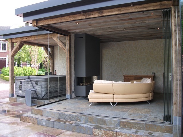 Black aluminum bifold glass doors fully opened connecting indoor living space to outdoor patio area
