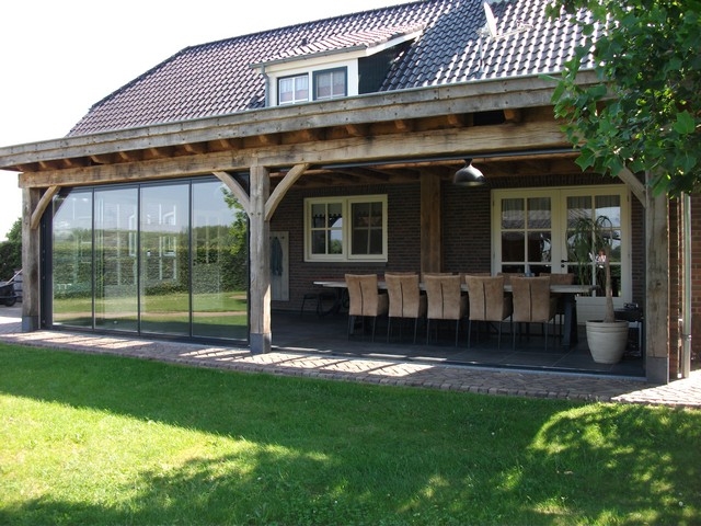 Black aluminum bifold glass doors fully opened connecting indoor living space to outdoor patio area