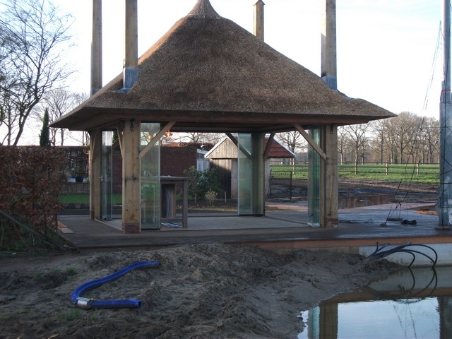 Black aluminum bifold glass doors fully opened connecting indoor living space to outdoor patio area