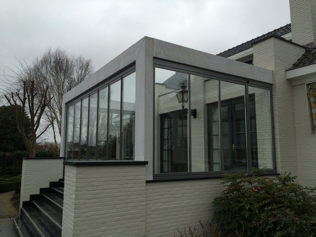 Black aluminum bifold glass doors fully opened connecting indoor living space to outdoor patio area
