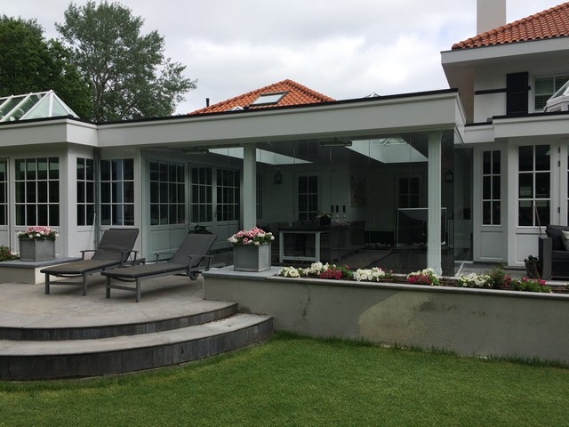 Black aluminum bifold glass doors fully opened connecting indoor living space to outdoor patio area