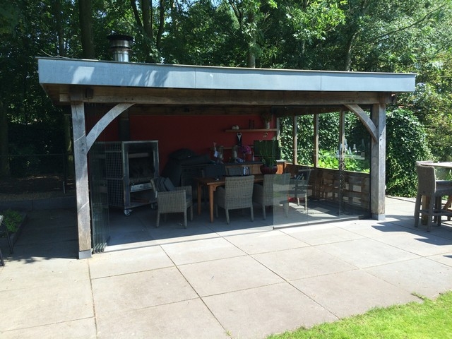 Black aluminum bifold glass doors fully opened connecting indoor living space to outdoor patio area