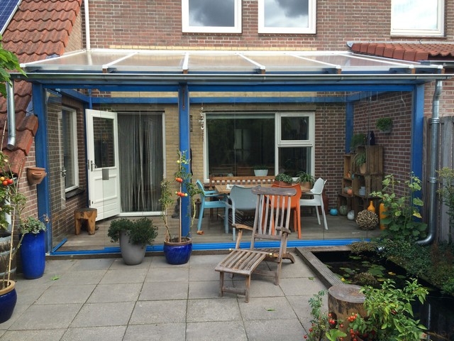 Black aluminum bifold glass doors fully opened connecting indoor living space to outdoor patio area