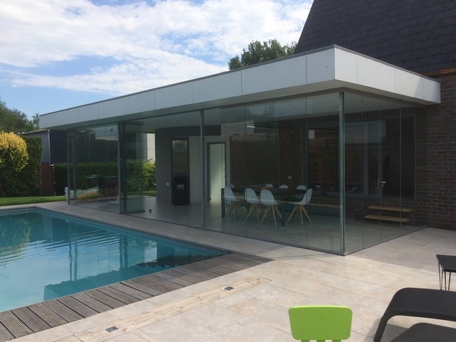 Black aluminum bifold glass doors fully opened connecting indoor living space to outdoor patio area