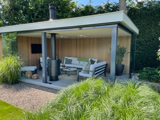 Black aluminum bifold glass doors fully opened connecting indoor living space to outdoor patio area