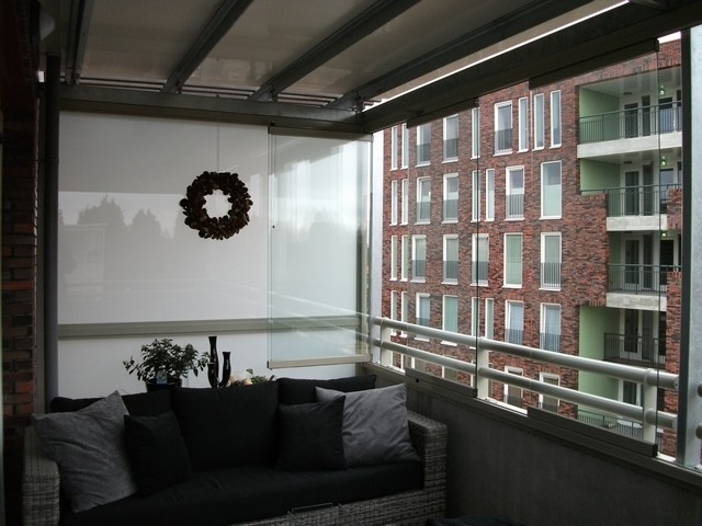 Black aluminum bifold glass doors fully opened connecting indoor living space to outdoor patio area