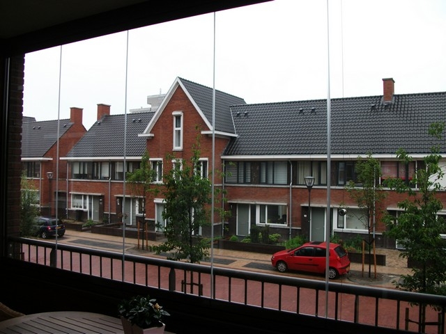 Black aluminum bifold glass doors fully opened connecting indoor living space to outdoor patio area