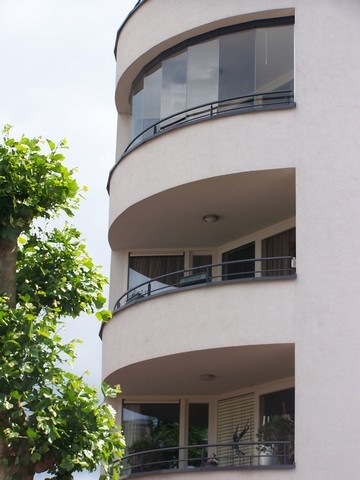Black aluminum bifold glass doors fully opened connecting indoor living space to outdoor patio area