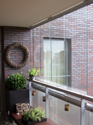 Black aluminum bifold glass doors fully opened connecting indoor living space to outdoor patio area