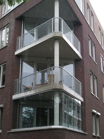Black aluminum bifold glass doors fully opened connecting indoor living space to outdoor patio area