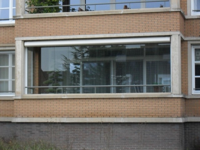 Black aluminum bifold glass doors fully opened connecting indoor living space to outdoor patio area