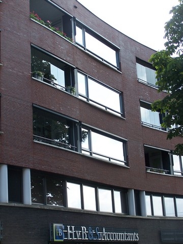 Black aluminum bifold glass doors fully opened connecting indoor living space to outdoor patio area