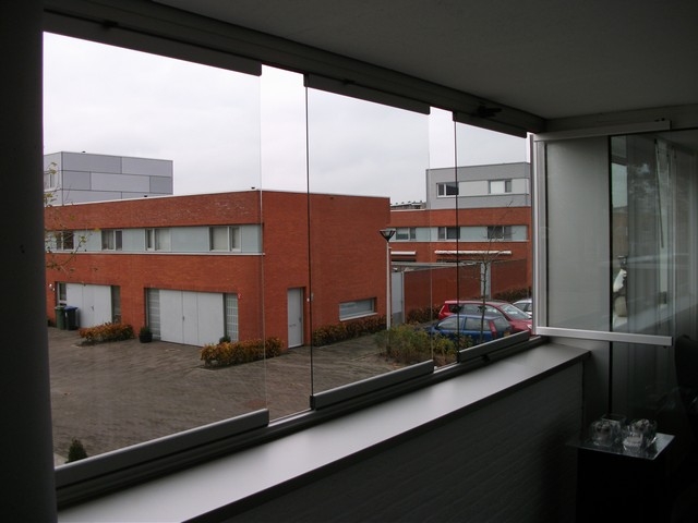 Black aluminum bifold glass doors fully opened connecting indoor living space to outdoor patio area