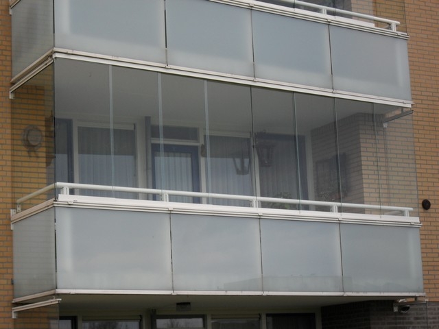Black aluminum bifold glass doors fully opened connecting indoor living space to outdoor patio area