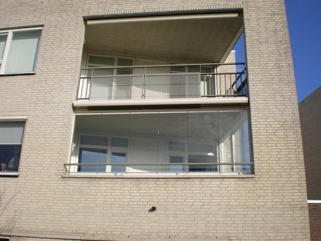 Black aluminum bifold glass doors fully opened connecting indoor living space to outdoor patio area