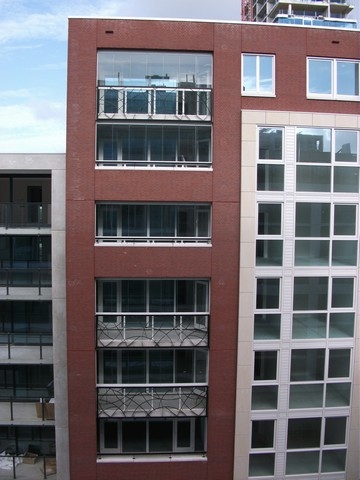 Black aluminum bifold glass doors fully opened connecting indoor living space to outdoor patio area