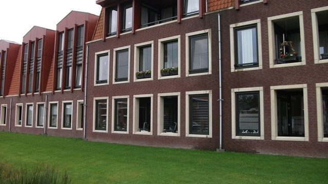 Black aluminum bifold glass doors fully opened connecting indoor living space to outdoor patio area