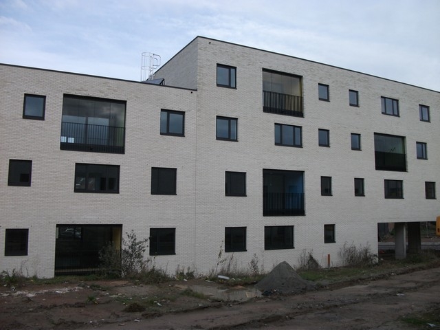 Black aluminum bifold glass doors fully opened connecting indoor living space to outdoor patio area