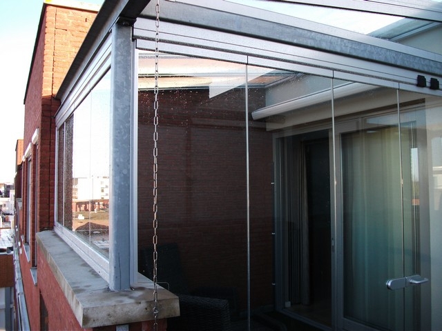 Black aluminum bifold glass doors fully opened connecting indoor living space to outdoor patio area