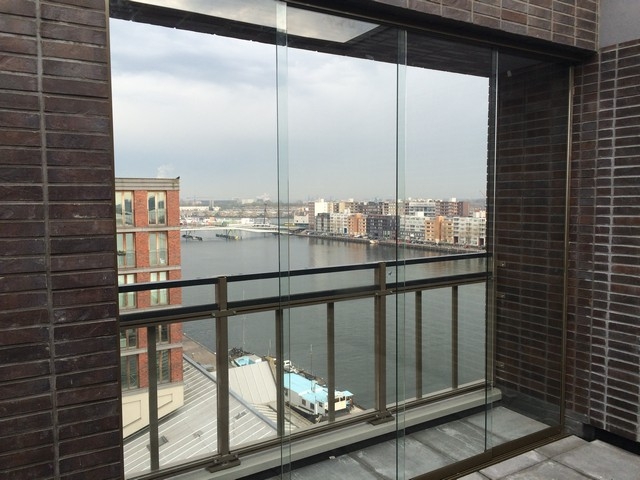 Black aluminum bifold glass doors fully opened connecting indoor living space to outdoor patio area