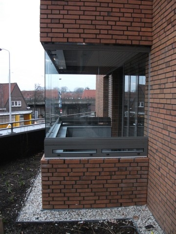 Black aluminum bifold glass doors fully opened connecting indoor living space to outdoor patio area