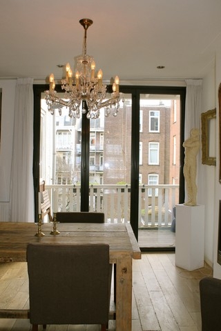 Black aluminum bifold glass doors fully opened connecting indoor living space to outdoor patio area