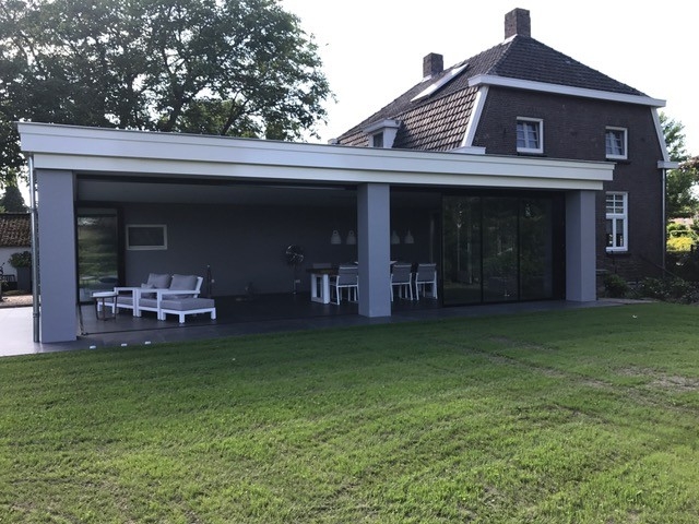 Black aluminum bifold glass doors fully opened connecting indoor living space to outdoor patio area