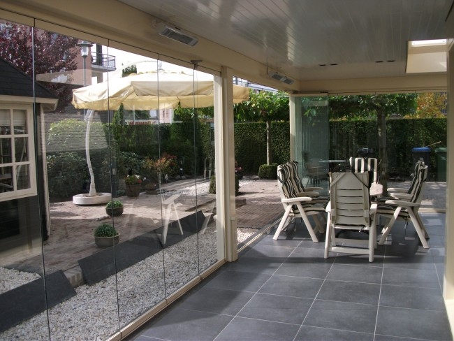 Black aluminum bifold glass doors fully opened connecting indoor living space to outdoor patio area