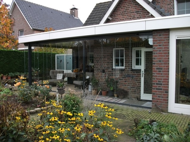 Black aluminum bifold glass doors fully opened connecting indoor living space to outdoor patio area