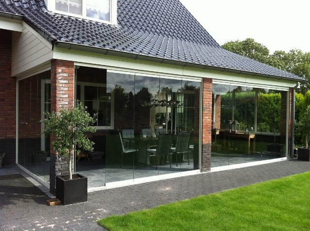 Black aluminum bifold glass doors fully opened connecting indoor living space to outdoor patio area