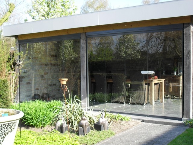 Black aluminum bifold glass doors fully opened connecting indoor living space to outdoor patio area