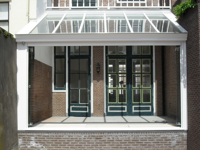 Black aluminum bifold glass doors fully opened connecting indoor living space to outdoor patio area
