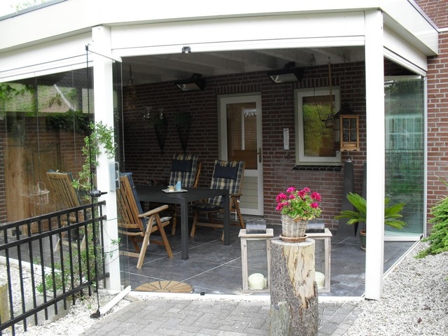 Black aluminum bifold glass doors fully opened connecting indoor living space to outdoor patio area