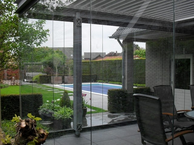 Black aluminum bifold glass doors fully opened connecting indoor living space to outdoor patio area