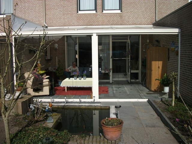 Black aluminum bifold glass doors fully opened connecting indoor living space to outdoor patio area