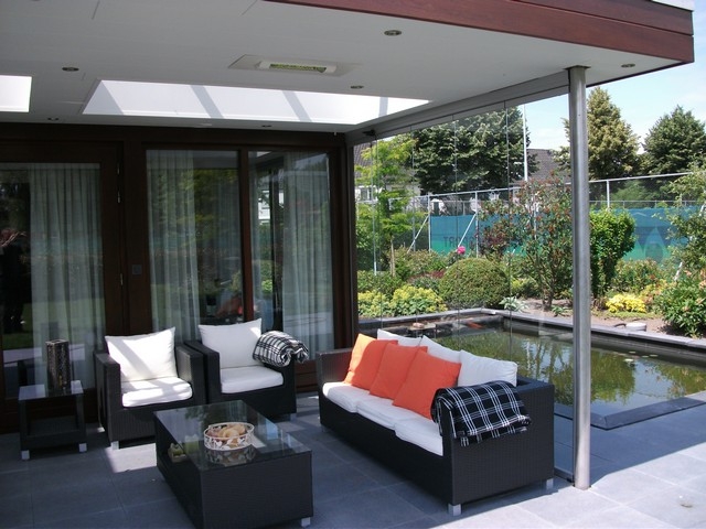 Black aluminum bifold glass doors fully opened connecting indoor living space to outdoor patio area