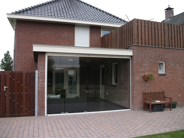 Black aluminum bifold glass doors fully opened connecting indoor living space to outdoor patio area