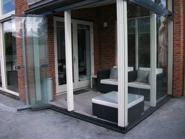 Black aluminum bifold glass doors fully opened connecting indoor living space to outdoor patio area