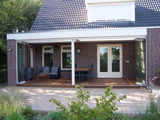 Black aluminum bifold glass doors fully opened connecting indoor living space to outdoor patio area