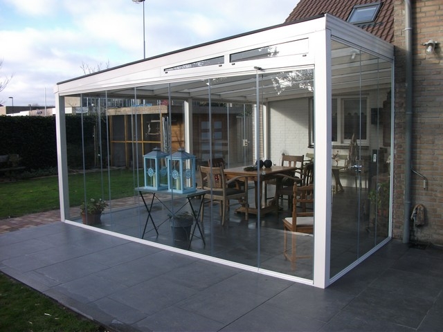 Black aluminum bifold glass doors fully opened connecting indoor living space to outdoor patio area