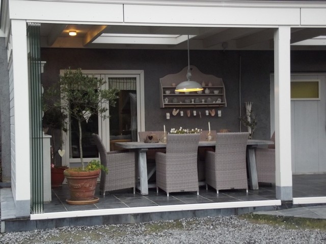 Black aluminum bifold glass doors fully opened connecting indoor living space to outdoor patio area